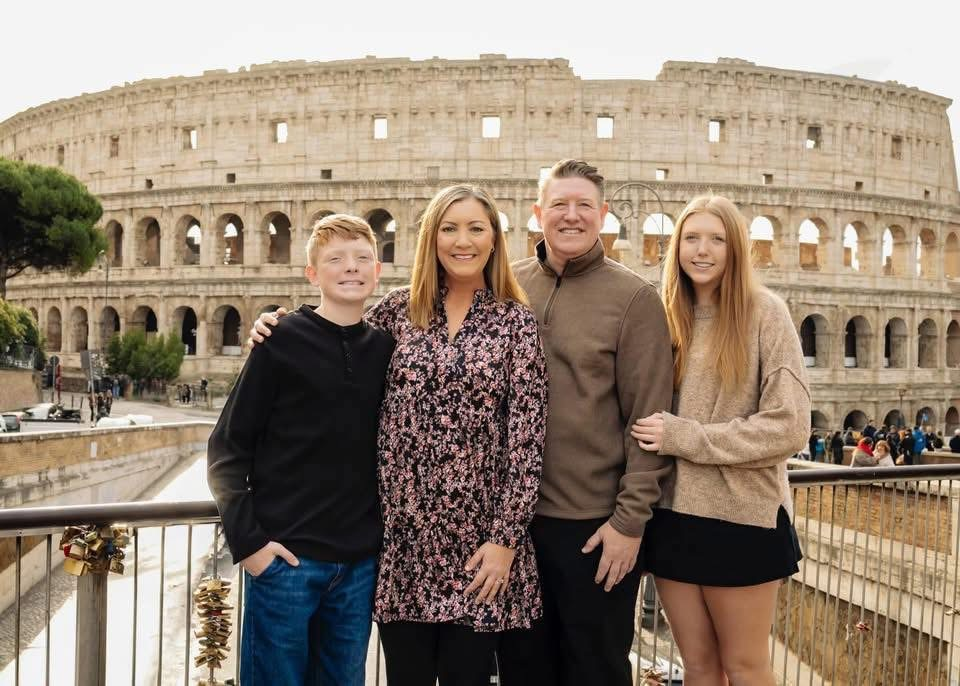 Mollie Romness with her family in front of the Colosseum in Rome