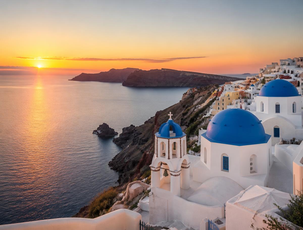 Blue-domed church and caldera view above Santorini, Greece